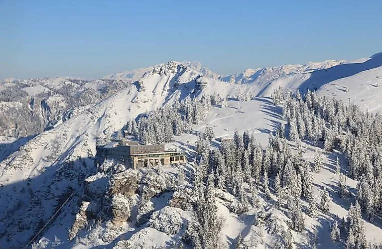 Snowy winter landscape with mountain hotel on the Predigtstuhl near Bad Reichenhall in the sunshine