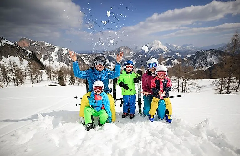 Family enjoying the snow-covered landscape in the Wurzeralm ski area near Spital am Pyhrn