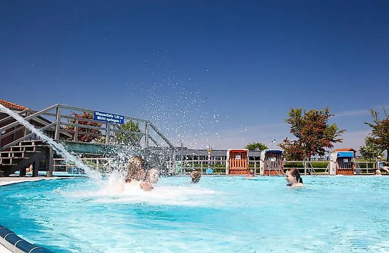 Families and children swimming in the open air at Friesland-Therme Horumersiel on a sunny summer's day