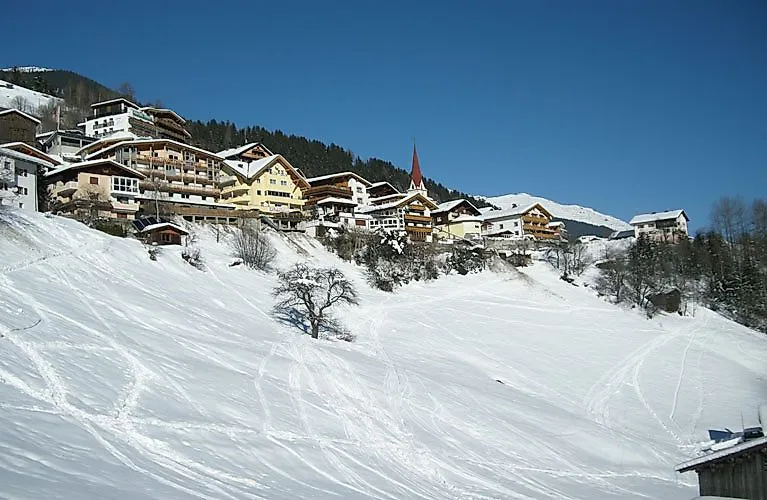 Kappl in Tyrol with snow-covered houses and church tower in winter
