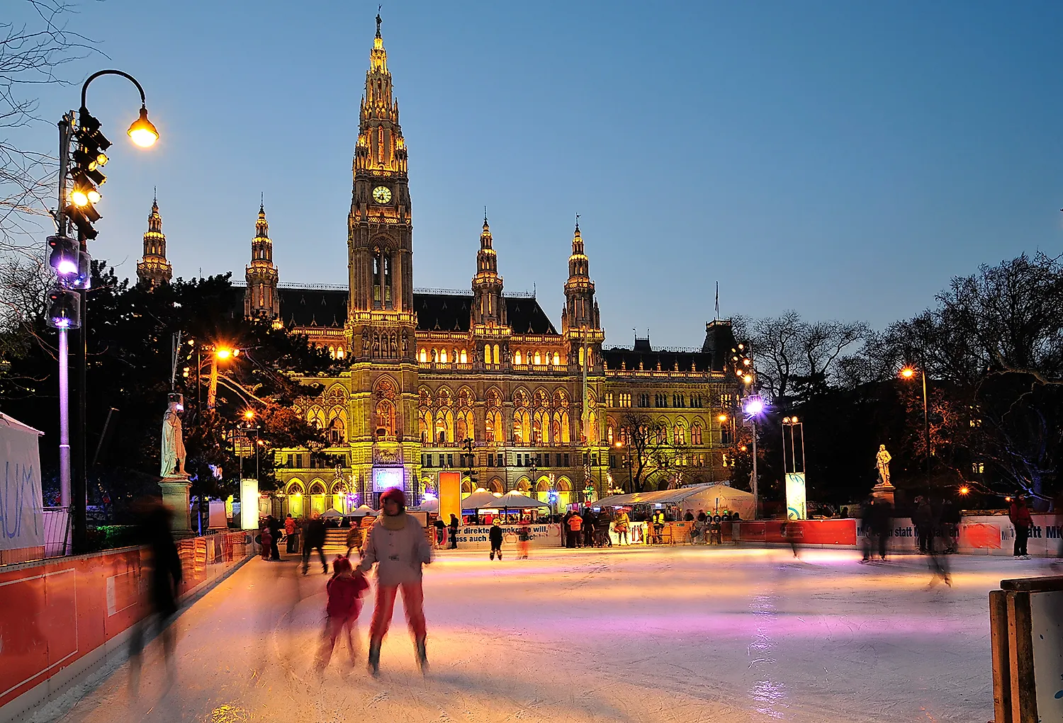 Vienna City Hall at night with illuminated City Hall Square and ice rink