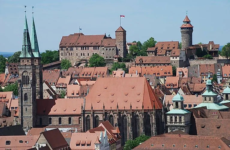 Panoramic view of Nuremberg's Imperial Castle and Old Town with churches and towers.