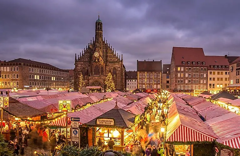 View of the festively illuminated Christkindlesmarkt with Frauenkirche in Nuremberg's Old Town.
