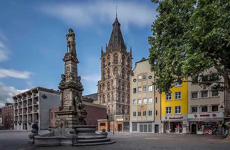 Historic Alter Markt with town hall tower and Jan von Werth fountain in Cologne's old town.