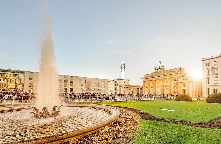 Fountain at Pariser Platz with a view of the Brandenburg Gate at sunset in Berlin-Mitte