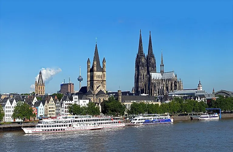 Panoramic view over the Rhine to Cologne's old town with the cathedral, St. Martin's Cathedral and ships.