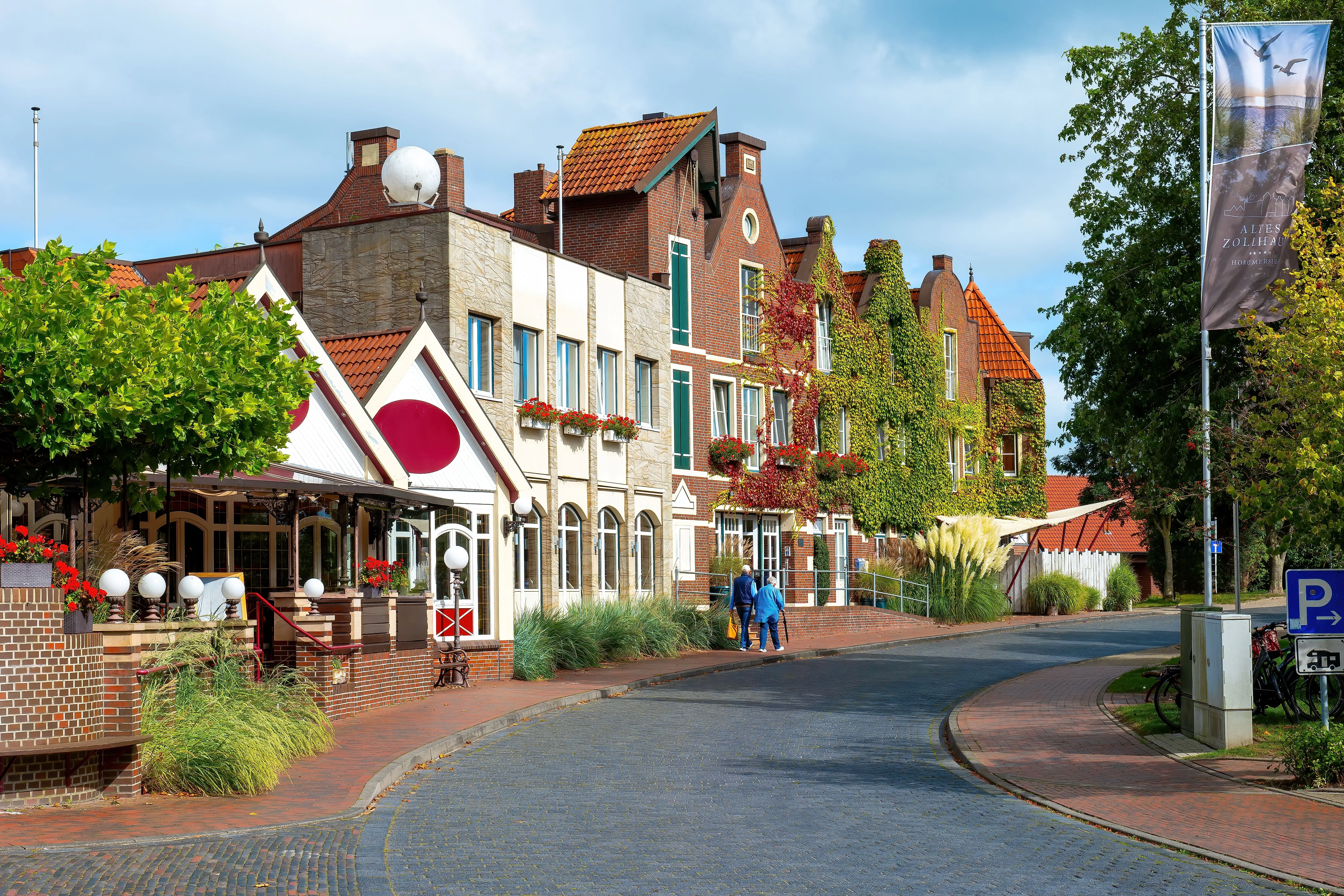 Historic houses and hotels in Horumersiel on the North Sea coast, with facades adorned with flowers