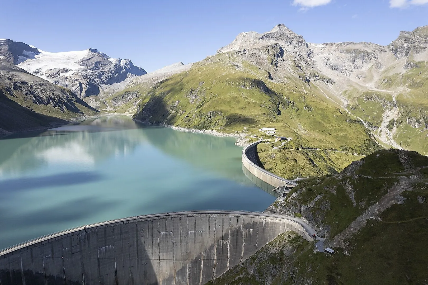 Vue sur les lacs de barrage de haute montagne de Kaprun aux eaux turquoise, entourés de montagnes majestueuses et de pentes montagneuses verdoyantes.