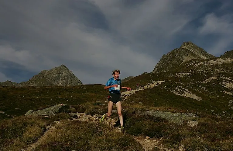Runners on a trail run through the mountain landscape above Kappl in Tyrol