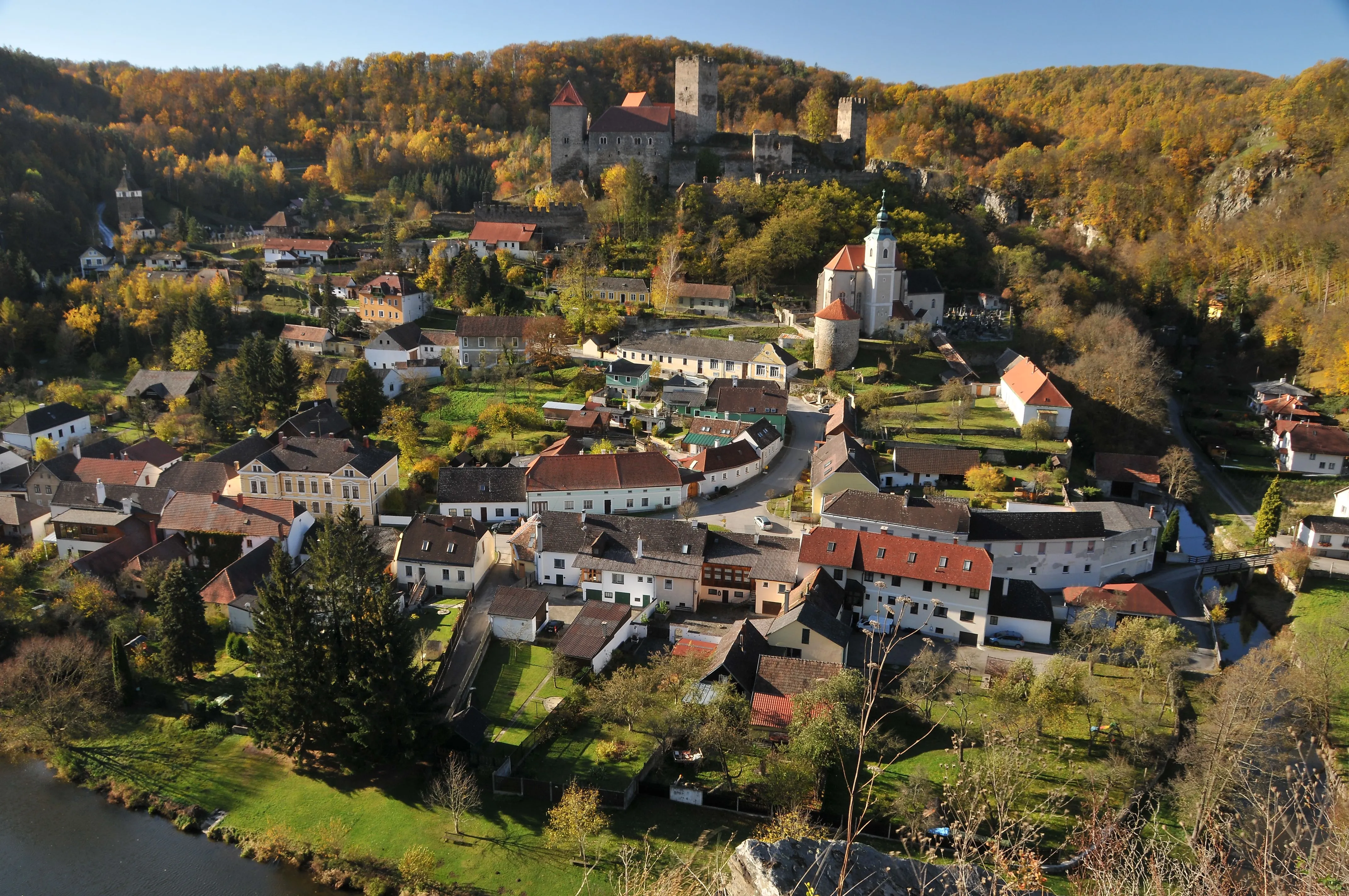 View of Hardegg with castle and church in the Thayatal National Park in autumn