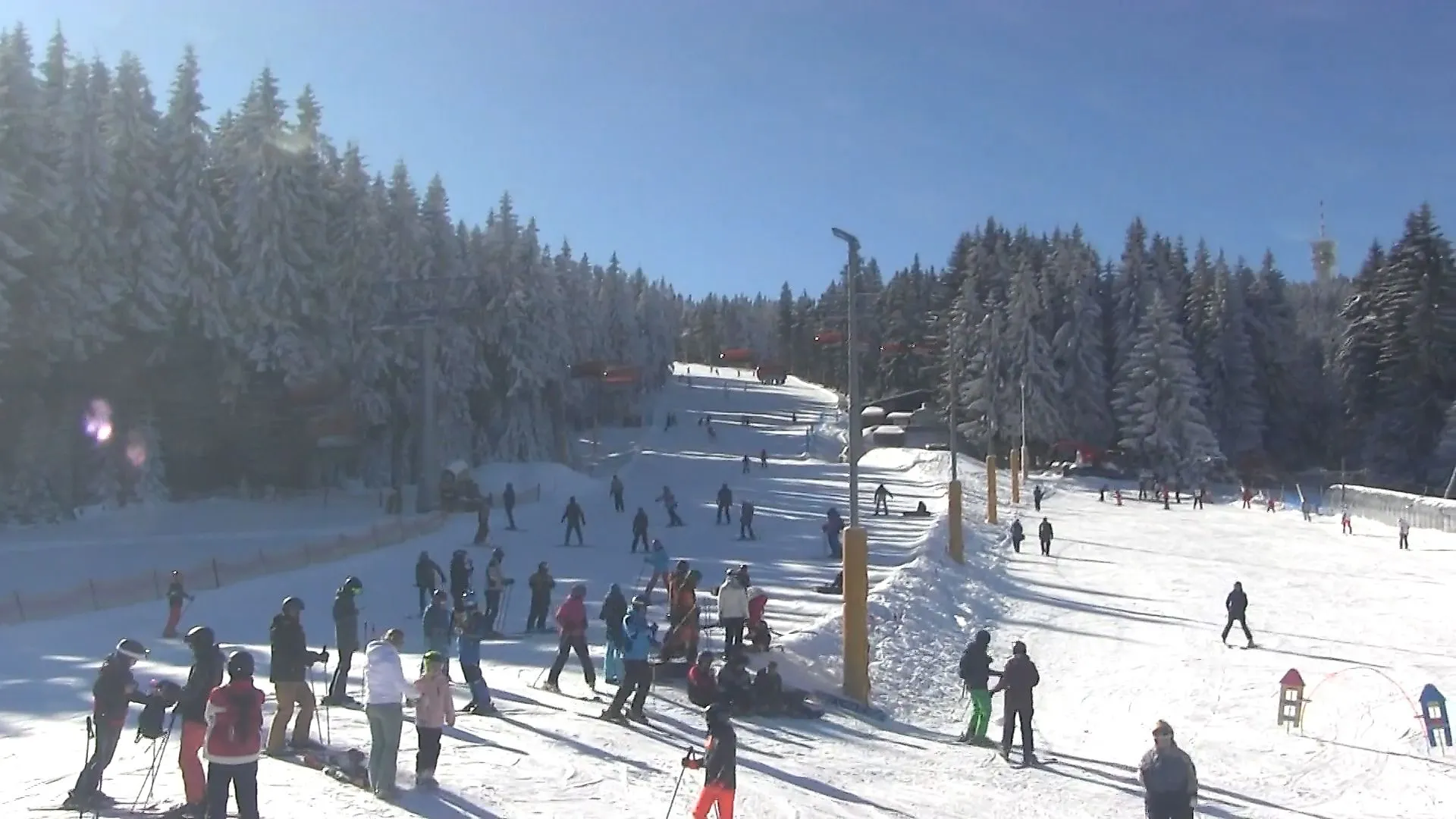 Blick mit der Webcam auf Skifahrer und verschneite Piste im Skigebiet Klínovec am Keilberg im Erzgebirge