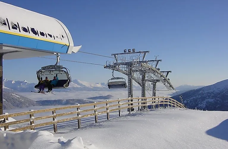 Winter am Katschberg: Sessellift mit Ausblick auf die verschneiten Berge zwischen Kärnten und Salzburg