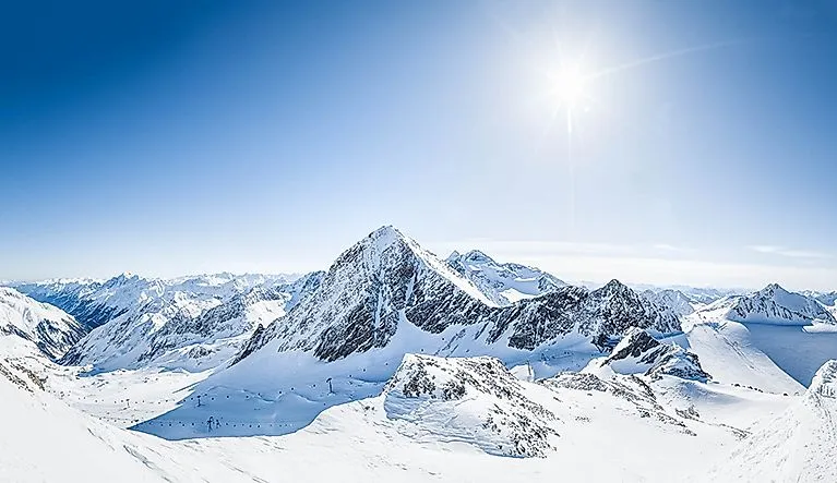 Wintery high mountain landscape with the Stubai Glacier under bright sunshine
