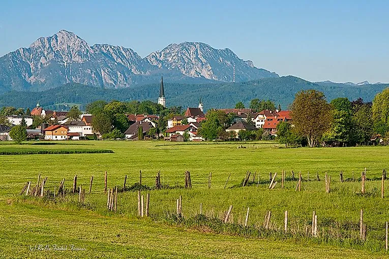 Summer landscape in Anger with a view of the village, church and mountains in the background
