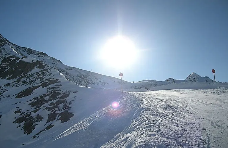Sun over ski slope in the mountains near Kappl in Tyrol